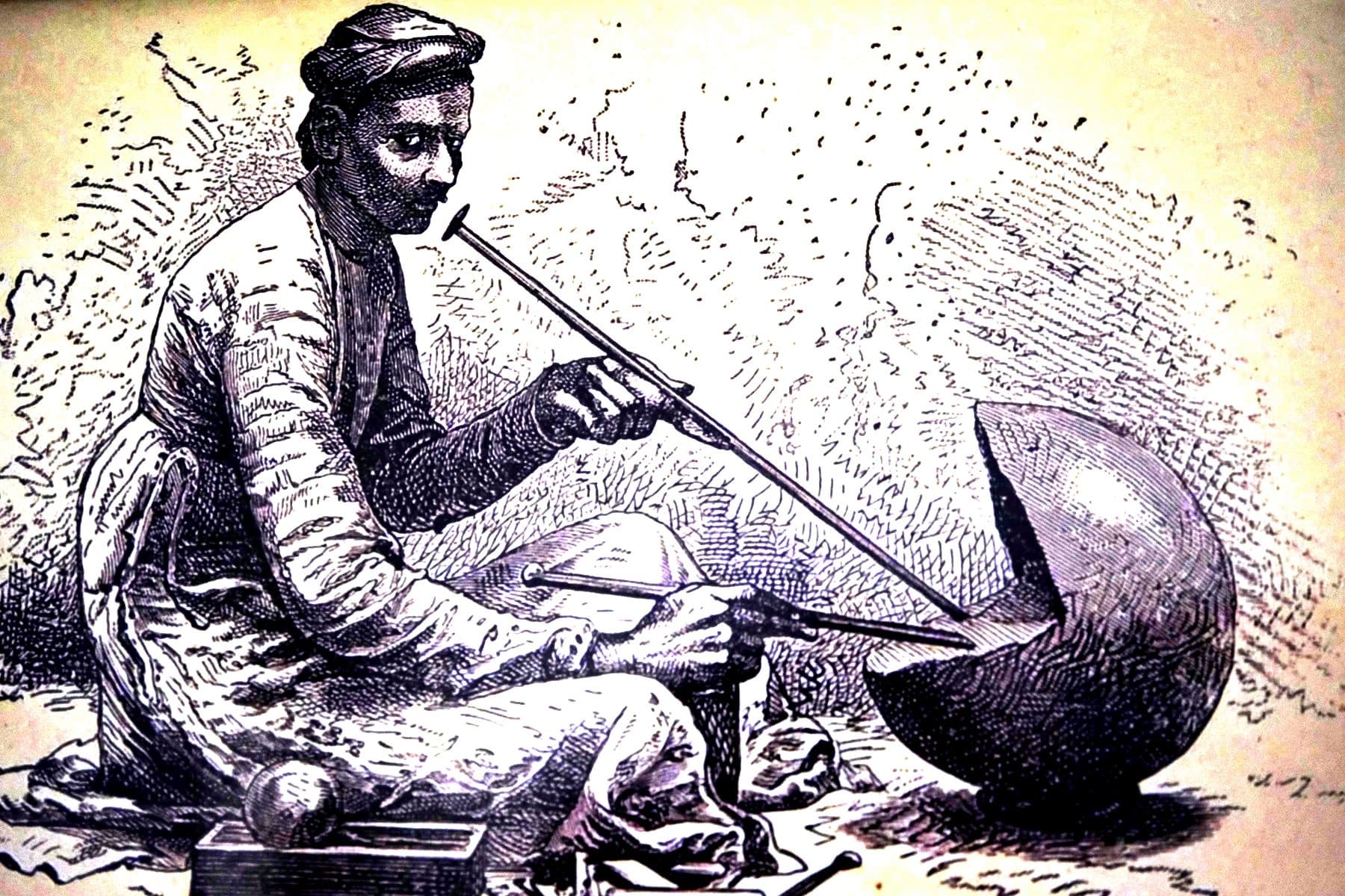 Nineteenth-century engraving of a goldsmith blowing a flame toward a crucible