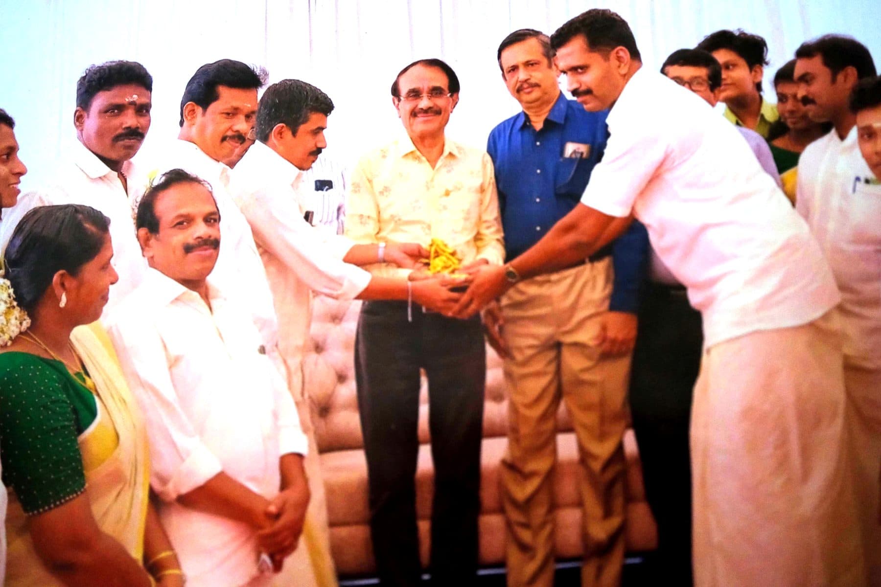 Workshop family being felicitated on stage at a trade gathering